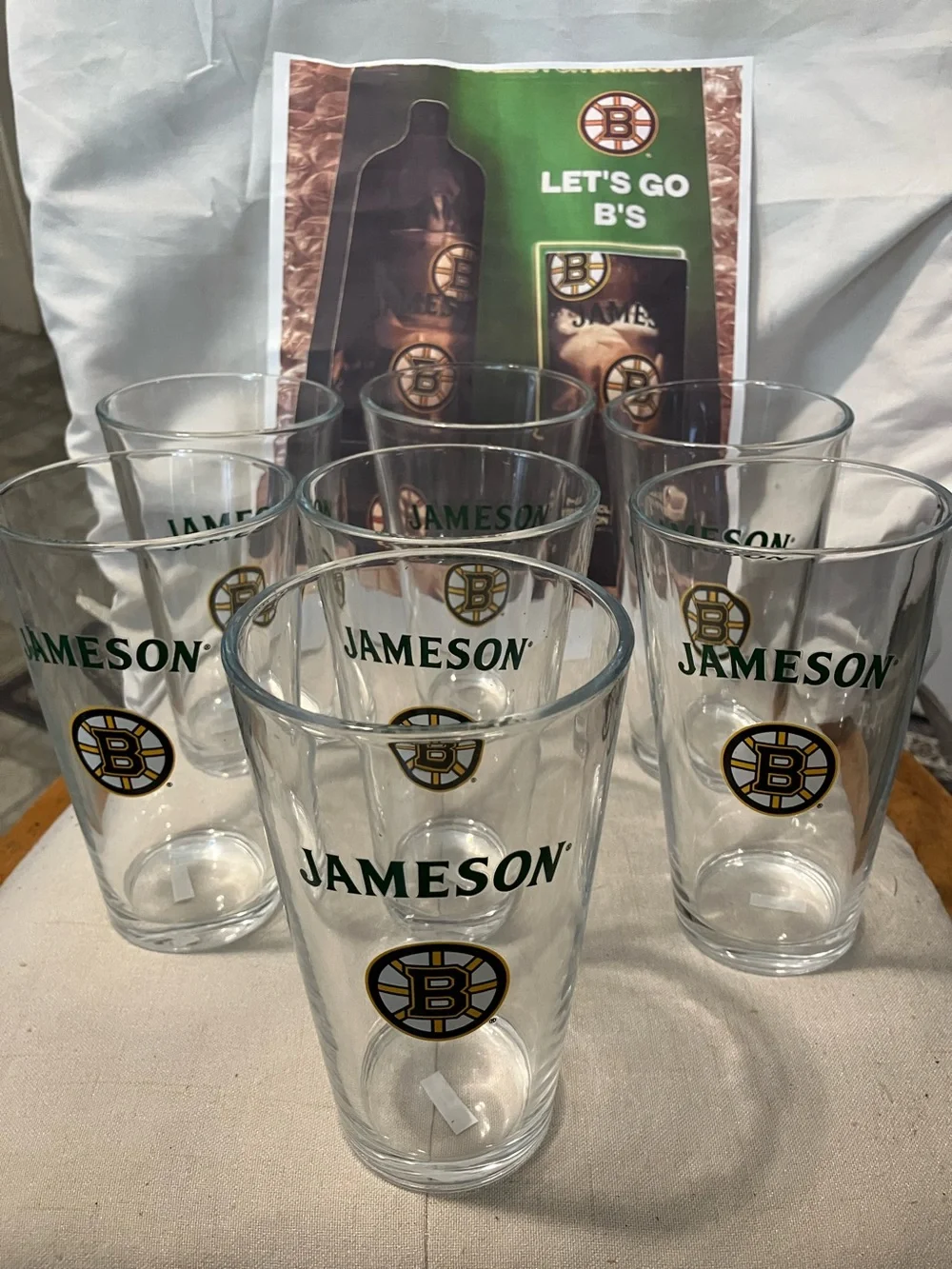 New. Set of 7 pint size glasses with Jameson - Boston Bruins logo on front